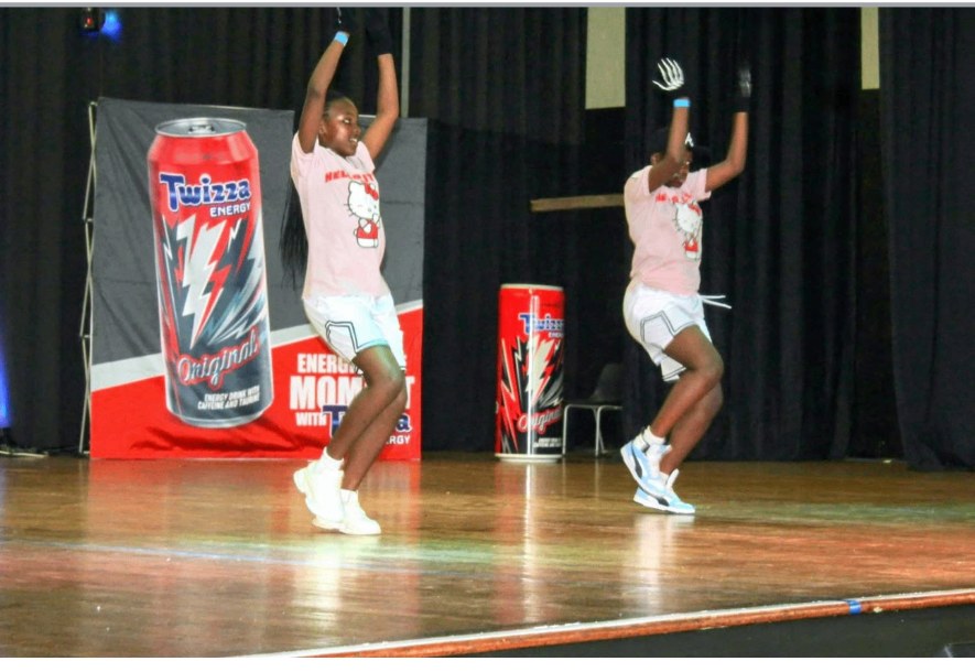 Two young dancers mid-routine on stage