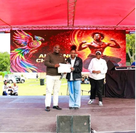 A young participant receiving a certificate on stage